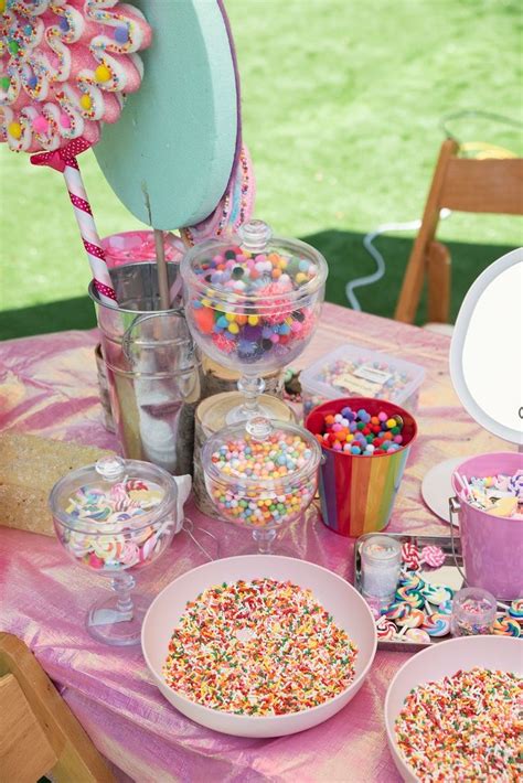 A Table Topped With Lots Of Cake And Candy