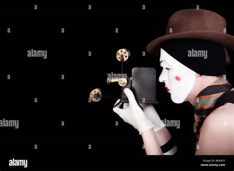 Portrait Of Mime In White Gloves And Brown Hat With Camera Stock Photo