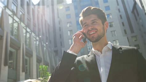 Young Pensive Businessman Talking On The Phone Outdoors Stock Video