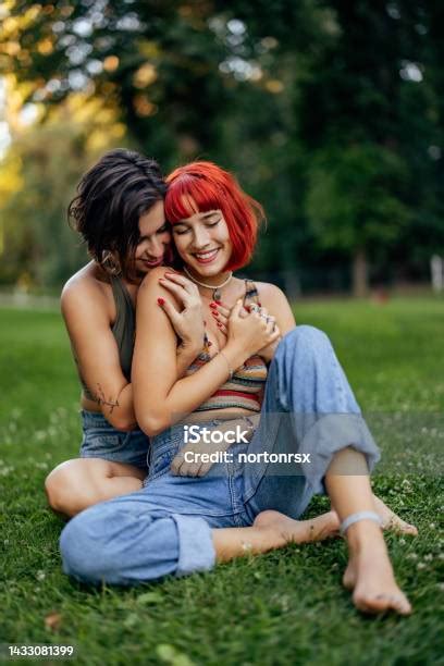 Adult Lesbian Girls Smiling And Sharing Love Sitting In The Pa Stock