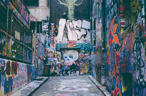 Colorful Grunge Graffiti Artwork Covering Walls In Alleyway With Skull