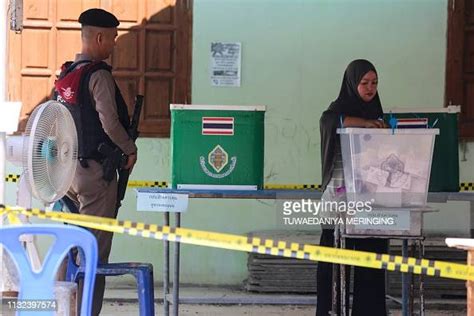 A Policeman Stands Guard As A Woman Casts Her Ballot At A Polling News Photo Getty Images