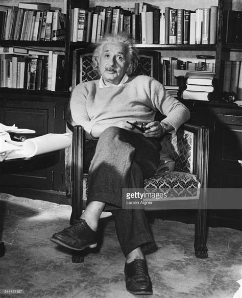 Portrait Of Physicist Albert Einstein Sitting In An Armchair With A