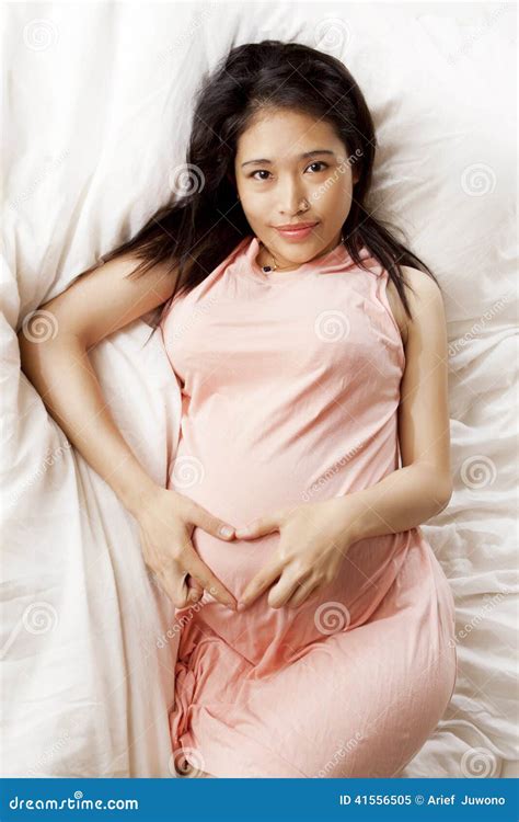 Pregnant Asian Woman On A Comfortable Bedroom Stock Image Image Of