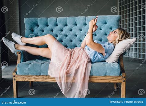 Beautiful Woman Is Lying On The Couch With Phone Stock Image Image Of Blond Lying 95033217
