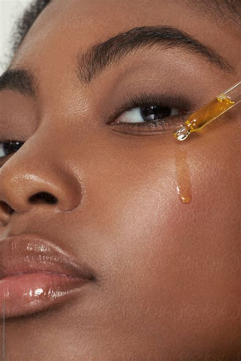 Model With Face Serum Dripping On Face By Hannah Criswell