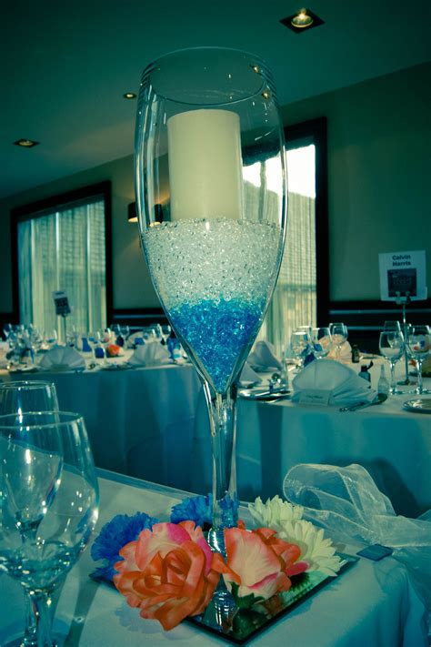 Top Table Centre Piece Tall Champagne Glass Filled With Beads Flowers On Mirror Plate Centre