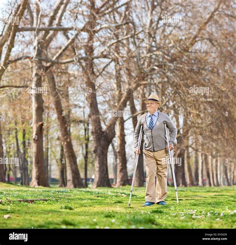 Senior Man Walking With Crutches Outdoors Stock Photo Alamy