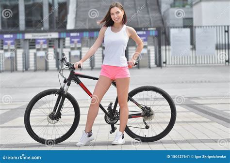 Beautiful Girl Riding A Bicycle In A City Standing With Bike Active People Outdoors Stock
