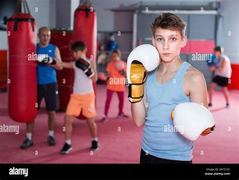 Teenage Boy Boxer In Gloves Posing During Boxing Training Stock Photo