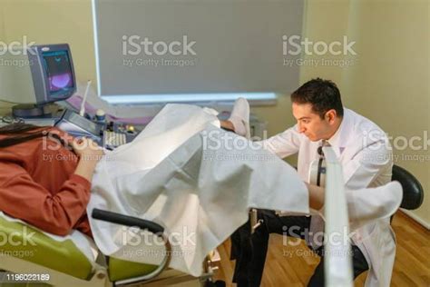 Woman In Gynecological Chair During Gynecological Check Up With Her