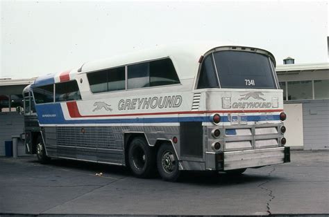 An Old Greyhound Bus Is Parked In Front Of A Storage Area At The
