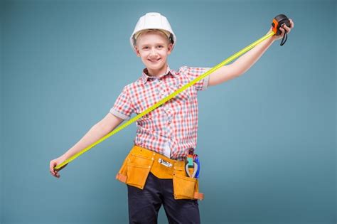 Premium Photo Portrait Of A Young Builder In A Helmet And A Tape