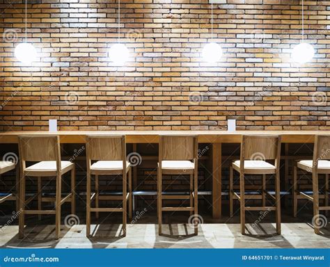 Table Counter Bar With Chairs And Lights Brick Wall Background Stock