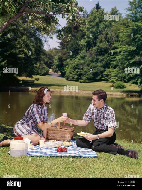 1960s Couple Picnic Man Woman Food Pond Picnics Eat Men Women Basket Outdoor Outside Grass