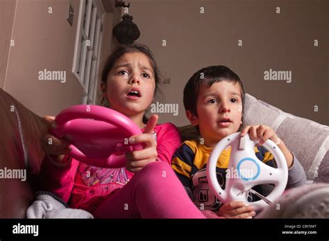 Siblings Playing Computer Game At Home Stock Photo Alamy