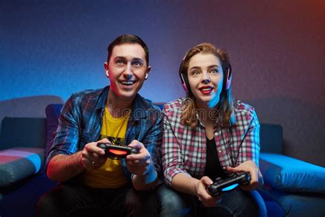 Portrait Of Crazy Playful Couple Gamers Enjoying Playing Video Games