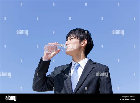 Young Businessman Drinking Mineral Water Stock Photo Alamy