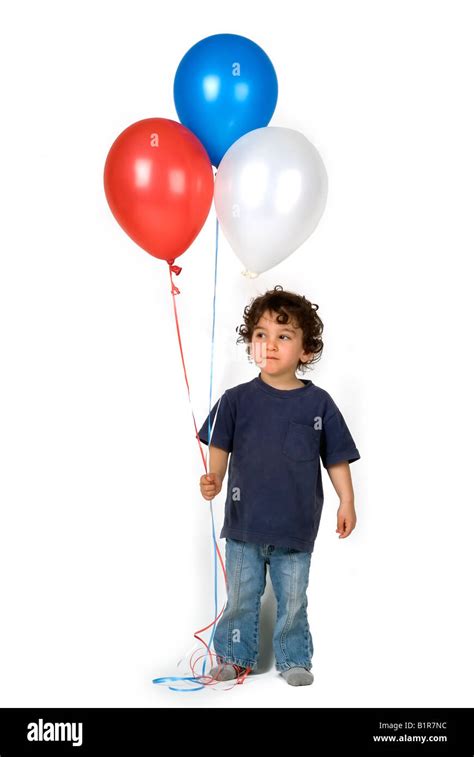 Little Boy Holding 3 Balloons Stock Photo Alamy