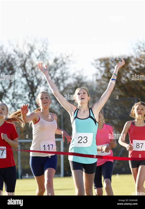 Runner Crossing Finish Line In Field Stock Photo Alamy