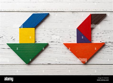 Wooden Tangram In Two Going Down Arrow Shapes Stock Photo Alamy
