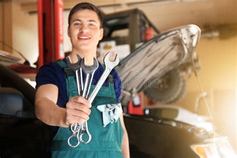 Young Auto Mechanic With Tools Near Car In Service Center Stock Image
