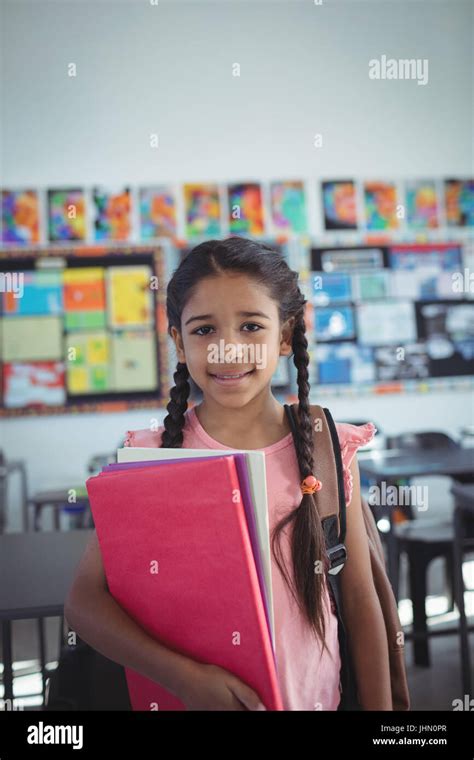 Portrait Of Girl With Books In Classroom Stock Photo Alamy