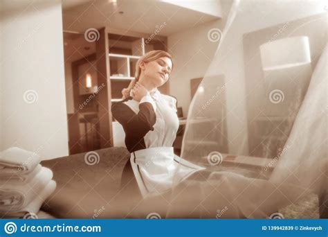 Young Hotel Maid Enjoying Light Summer Wind From The Window Stock Image