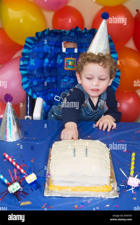 Two Year Old Boy Celebrates His Birthday With His Finger In The