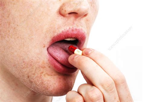 Man Taking An Antibiotic Capsule Stock Image C029 7916 Science Photo Library
