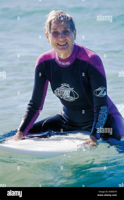 Australia Queensland Mature Woman On Surfboard Stock Photo Alamy