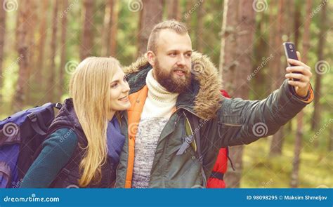 Young Beautiful Couple Walking In Forest And Taking Selfie On A Stock Image Image Of Concept