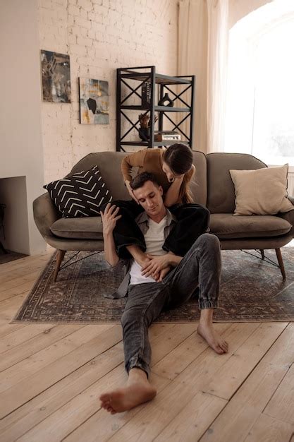 Premium Photo Young Couple Hugging And Kissing At Home In Loft Style