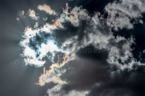 The Sun Shining Through Dark Clouds With Sunrays Stock Image Image Of