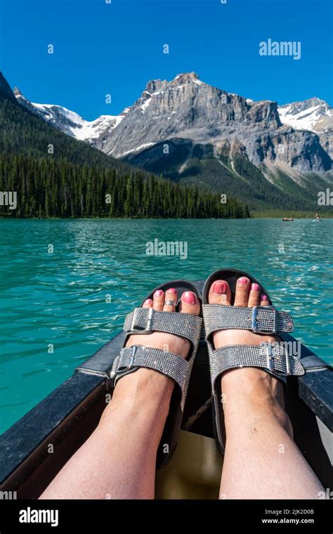Sparkly Sandals And Womens Feet Relaxing On A Canoe On Emerald Lake