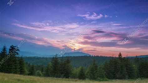 Sunset In The Cloudless Sky Over Wooded Mountains Time Lapse Stock