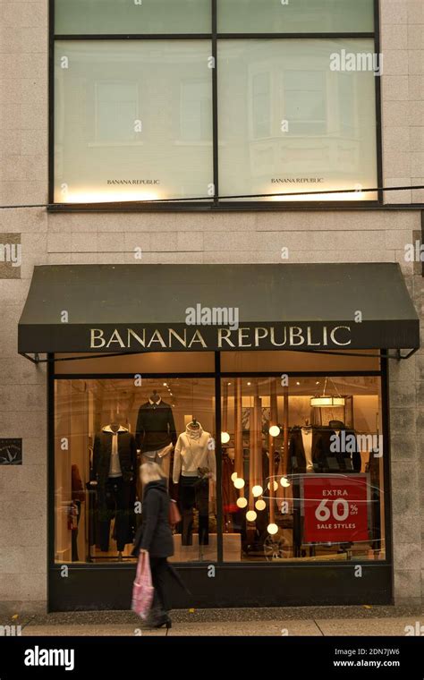 Woman With Shopping Bag Walking By The Banana Republic Clothing Store
