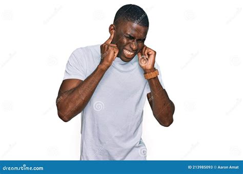 Young African American Man Wearing Casual White T Shirt Covering Ears