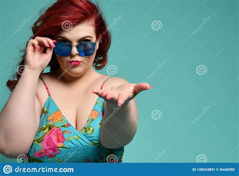 Overweight Woman In Sunglasses And Sundress Holds Out Her Hand With