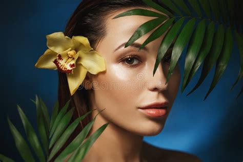 Natural Beauty Concepts Beautiful Woman With Plants Looking At Camera