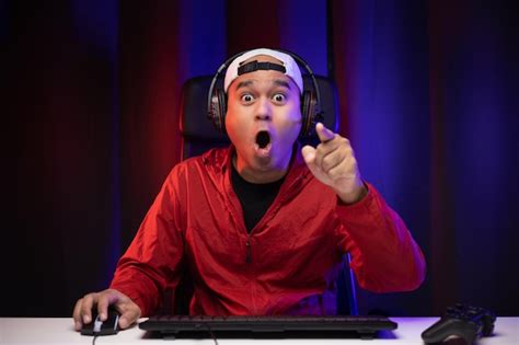 Premium Photo Excited And Shocked Face Of Asian Gamer With Headphone