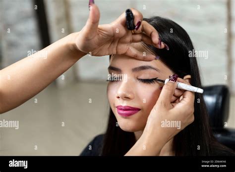 A Young Indian Model At A Beauty Salon Makeup Artist Applying Eyeliner