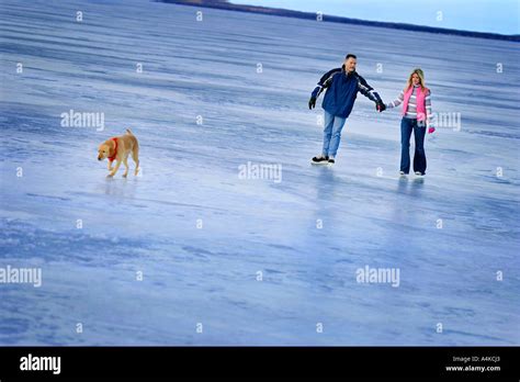 Couple Skating On A Frozen Lake Stock Photo Alamy
