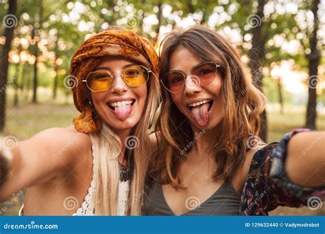Photo Of Two Stylish Hippies Women Smiling And Taking Selfie While