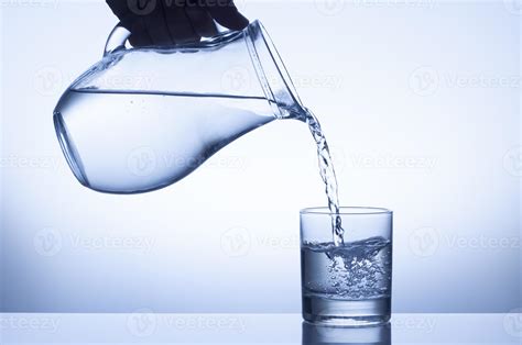 Water Being Poured From A Pitcher Into A Glass 1251583 Stock Photo At