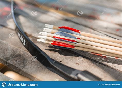 Traditional Wooden Arrows With Feather Fletching And A Wooden Bow Stock