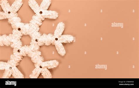Fluffy White Snowflake Christmas Decor Image Toned In Peach Fuzz Color