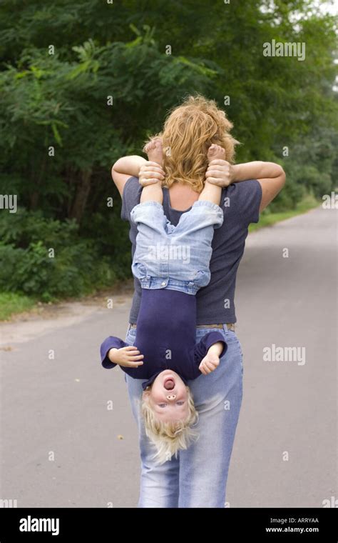 Child Carried Head Down Stock Photo Alamy