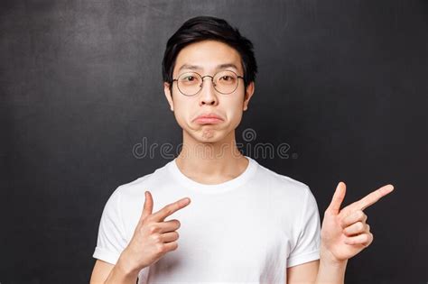 Close Up Portrait Of Impressed Asian Man In Glasses White T Shirt Pouting And Looking Camera