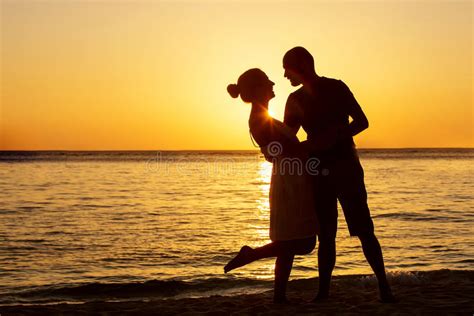 Romantic Couple On The Beach At Colorful Sunset Stock